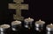 Lit Tea Candles with Crucifix with dark Background