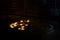 The lit up candles stood by prayers in the darkness of a church room at Notre Dame Cathedral, Paris