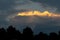 Lit yellow sunlight thundercloud at sunset