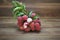 Litchi chinensis fruit with leaves peeled to show the flesh white on wooden background.