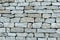 Lite stone background gray light, pattern old natural uneven cobblestone