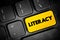 Literacy is the ability to read, write, speak and listen, text button on keyboard, concept background