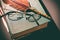Literature concept. Vintage still life with glasses on old books near feather or quill. Close up