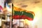 Lithuania Flag Against City Blurred Background At Sunrise Backlight