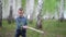 Litle boy walk in a birch grove on a spring day