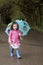 A litle girl with a blue umbrella