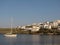 Litle sailing yacht anchored near a greece maritime town.
