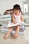 Litlle girl reading lot of books