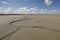 Litlle river flowing on the beach into sea, Somme Bay, Picardy, France