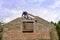Litovel, Czech Republic August 3th 2018, Builder standing on a roof timber construction and finishing brick gable of an