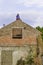 Litovel, Czech Republic August 3th 2018, Builder standing on a roof timber construction and finishing brick gable of an