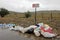 Littering of garbage in front of do not litter sign, Chile