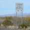 Littering Highways Unlawful Sign with litter on the ground below. Mohave County, Sonoran Desert, Arizona USA