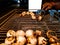 Litti, a common north indian food is being baked road side on a coal grill by vendor with white mockup ad space in the background