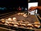 Litti, a common north indian food is being baked road side on a coal grill by vendor with white mockup ad space in the background