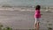 Little 5-year-old girl playing on the beach
