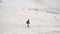 Little 6 years old boy with backpack hiking in High Snowy Mountains. He walk and waves