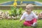 Little active emotional child playing on grass in beautiful park.