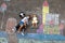 Little active kid boy and cute toddler baby girl drawing knight castle and fortress with colorful chalks on asphalt