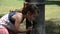 Little adorable baby girl drinks water from the drinking fountain of the roman nose on the streets of Rome