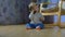 Little adorable baby takes a phone and smiles while sitting on the floor