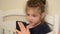 Little adorable girl child talking by video call on smartphone