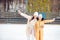 Little adorable girl with her mother skating on ice-rink