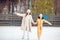 Little adorable girl with her mother skating on ice-rink