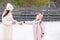 Little adorable girl with her mother skating on ice-rink