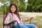 Little adorable girl relaxed and happy, sitting on a folding chair for travel