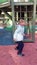 Little adorable girl in school pants dancing after school on the playground.