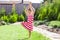 Little adorable girl standing in a yoga pose on