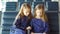 Little adorable girls in airport waiting for boarding and playing with laptop