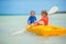 Little adorable girls enjoying kayaking on yellow kayak