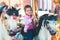 Little adorable smiling girl riding a horse on roundabout carousel at funfair