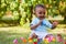 Little african american baby boy playing in the grass