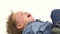 Little african american boy lies on the floor and cries, he`s upset. White background