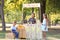 Little African-American boy selling lemonade at counter in park