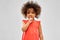 Little african american girl making shush gesture