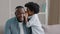 Little african american kid girl shares secret with dad tells amazing fun story in ear funny father smiling listening to