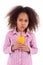 Little african asian girl drinking orange juice