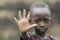 Little African boy showing Palm as STOP sign to racism, war and fight