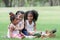 Little African and Caucasian kids picnic and playing in the park. Little cute girl hugging and consoling her crying friend.