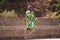 Little African Girl With a Beautiful Green Dress Concentrating on Her Skipping Performance