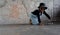 Little African kid boy wear cool gold sunglasses, hat, necklace chain and sneaker smiling and have fun lying on skateboard