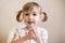 Little amazed kid girl with wide open eyes closeup portrait on plain background