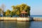 Little arbor rotunda surrounded by trees in the embankment at sunny autumn day. Travel and tourism concept