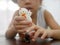 Little Asian baby girl enjoys playing finger dolls at home