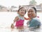 Little Asian baby girl enjoys playing water in a river with her auntie