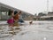 Little Asian baby girl enjoys playing water in a river with her auntie